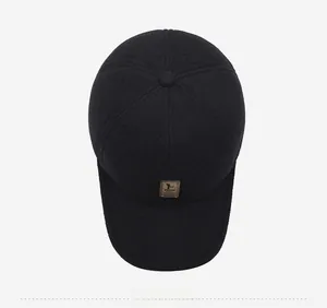 Top view of a black winter baseball cap with thick wool fabric and a brown leather logo