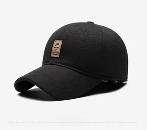 Close-up of black winter baseball cap with thick textured fabric and leather sport patch