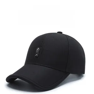 Detail view of a black baseball cap featuring a leather patch and metal rivets
