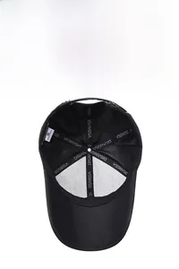 Detail view of black baseball cap interior featuring DISANGSA logo tape and size S label