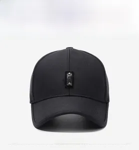Front detail of black baseball cap with leather patch and silver rivets on twill fabric