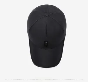 Top down view of black cotton baseball cap showing reinforced seams and peak leather patch
