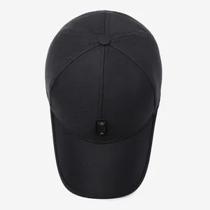 Overhead view of black cotton baseball cap with leather logo patch and metal rivets