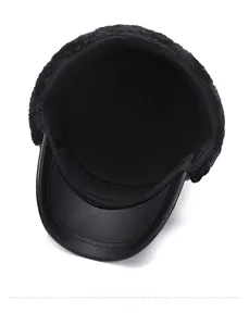 Detail of warm faux fur lining and premium leather brim on black winter flat cap