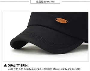 Close-up of black cotton twill hat brim with double stitching and a sport wood tag