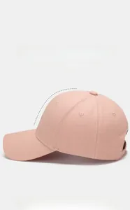 Side view of pink structured baseball cap with hard top design and curved brim stitching