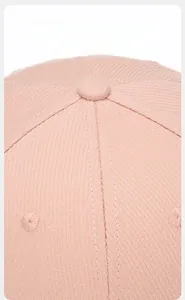 Macro detail of breathable pink baseball cap fabric with reinforced stitching and top eyelets