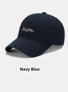 Detailed view of Raiyan gold embroidery and navy blue twill fabric on baseball cap
