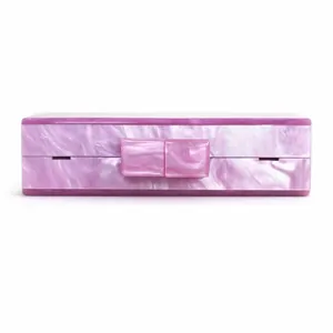 Detail of lavender pearlescent acrylic evening clutch with marble texture and square clasp