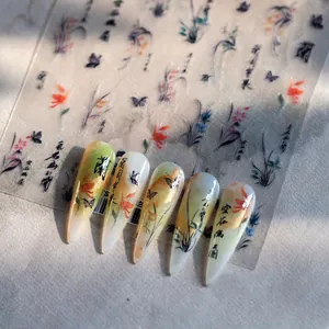Macro detail of Chinese ink style nail stickers with orchid and butterfly patterns