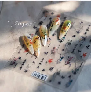 Detail of Chinese ink painting nail stickers featuring floral motifs and calligraphy