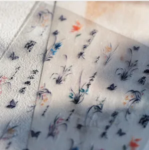 Macro view of matte PET stickers with orchid patterns and Chinese calligraphy