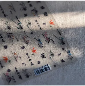 Detail of Chinese ink style nail stickers with orchid, butterfly and calligraphy patterns