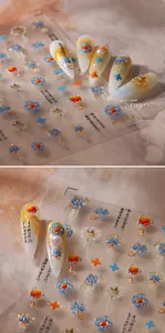 Detailed close-up of Chinese style nail stickers with blue lotus and gold foil accents