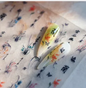 Macro detail of almond nail tips featuring ink-style orchid and butterfly motifs