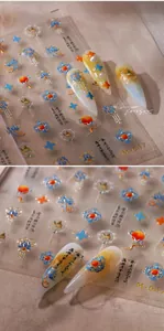 Macro detail of M-647 Chinese style nail art stickers with lotus and gold foil accents