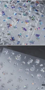 Detailed macro view of 3D holographic nail art stickers with butterfly and shell patterns