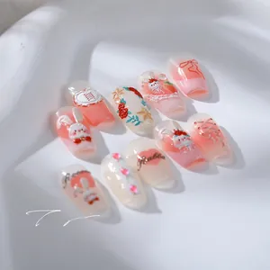 Detailed macro view of 5D embossed nail charms featuring pink gradient rabbits and bows