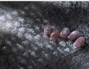 Macro detail of TL-240 3D nail art stickers with white lace bows and embossed flower designs
