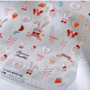 Detailed 5D embossed nail art stickers featuring Rococo white rabbits and red strawberries