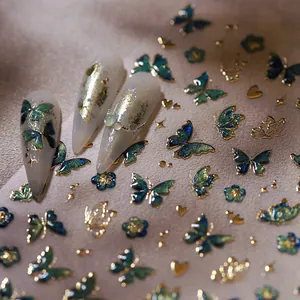 Embossed butterfly nail stickers with gold stars and hearts on almond press-on nails