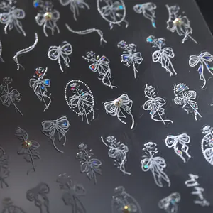 3D embossed nail art stickers with white bow heart and floral patterns on dark background