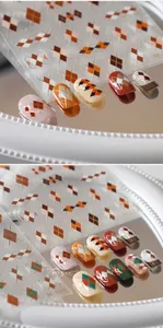 Detail of argyle pattern nail stickers with gold accents and warm autumn tones
