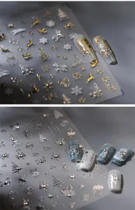 Detail of 5D embossed Christmas nail stickers with gold and silver reindeer and snowflake
