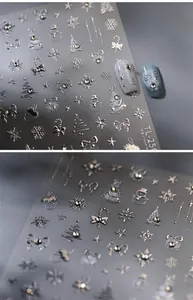Macro detail of 3D silver Christmas nail stickers with snowflakes and bows TL-256