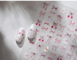 Macro detail of pink bow and rabbit nail art stickers with sparkling laser effects