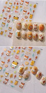 Detail of fox-themed embossed nail art stickers with golden shimmer and autumn leaves