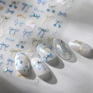 Bow and rabbit laser nail stickers with iridescent finish and blue accents