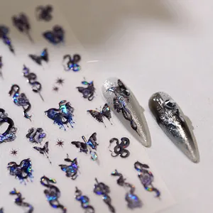 Detailed macro view of 3D embossed nail art stickers with iridescent snake and butterfly motifs