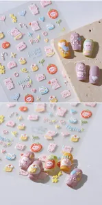 Detail of 3D embossed nail art stickers featuring cute pink cartoon pigs and hearts