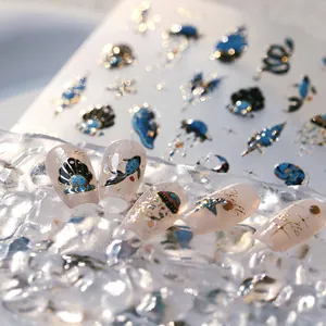 Marine themed 3D nail art stickers with gold shell and jellyfish designs on nude nails