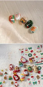 Macro detail of 3D embossed Christmas nail art stickers with Santa and snowman patterns