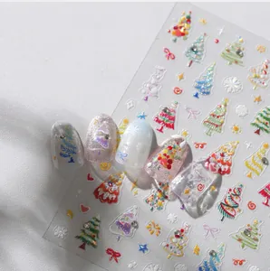 Macro detail of 3D embossed Christmas nail stickers featuring colorful trees and snowflakes