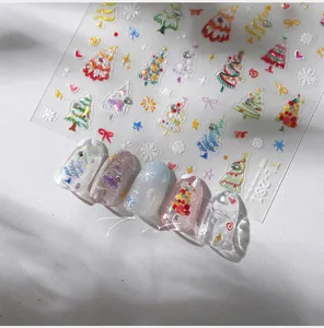 Close-up of 3D embossed Christmas tree nail stickers with snowflake and glitter details