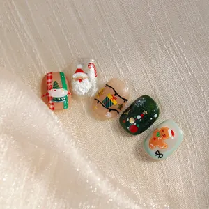 3D Christmas press-on nails set with Santa, gingerbread man and festive tree designs