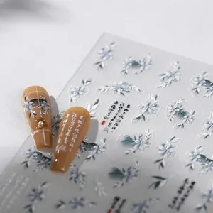 Golden flower nail stickers with ink floral design and Chinese calligraphy on caramel nails