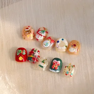 3D Christmas themed press-on nails featuring snowman, reindeer, and red bow designs