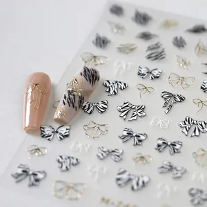 Embossed 3D nail art stickers with zebra bow designs and golden metallic foil textures