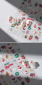 Close-up of Christmas nail art stickers featuring Santa, reindeer and snowflake patterns