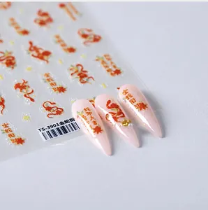 Macro detail of Year of the Snake nail art stickers with red gold serpent and leaf motifs