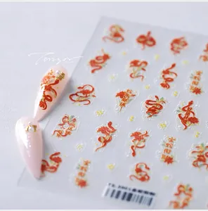 Detail of red and gold snake zodiac nail decals with Chinese lucky characters