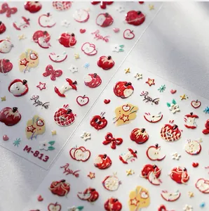 Detail of M-813 embossed nail stickers featuring cute red apple and bow tie patterns
