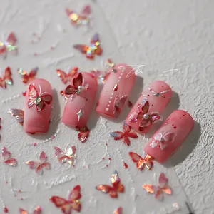 Detailed close-up of 5D butterfly nail art stickers with pink gradient and micro pearls