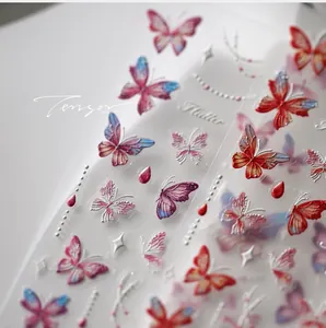 Macro view of 5D embossed butterfly nail stickers with colorful metallic glitter gradients