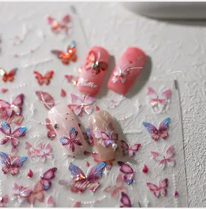 Close-up of 5D holographic butterfly nail stickers with Flutter text on pink nails