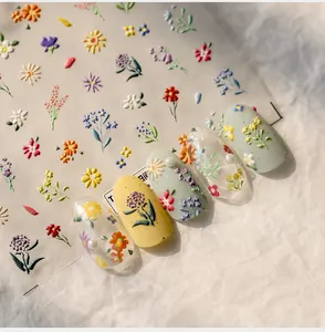 Detailed 5D embossed nail art stickers with colorful floral daisy patterns on white background